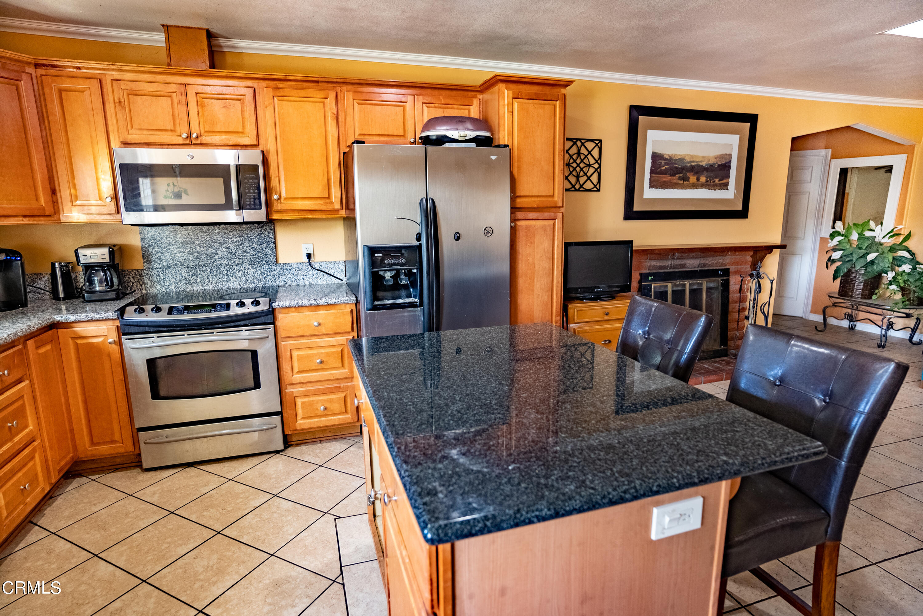 4731 Reading Drive Oxnard, CA 93033 - Photo 5 of 25 a kitchen with stainless steel appliances granite countertop a stove a refrigerator and a microwave