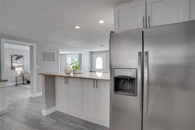 a kitchen with a refrigerator and a sink