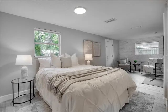 a bedroom with a bed a table and chair