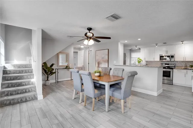 a view of a dining room with furniture and wooden floor