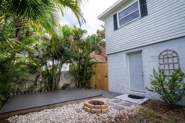 a backyard of a house with a tree