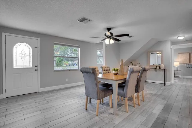 a view of a dining room with furniture window and wooden floor