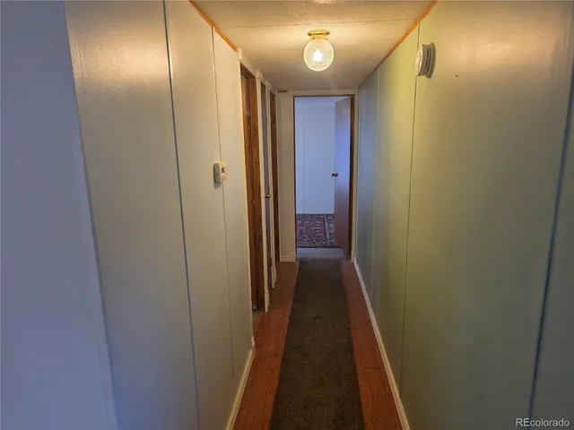 a view of hallway with wooden floor