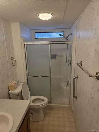a bathroom with a toilet and a shower