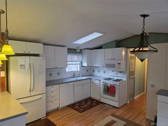 a kitchen with stainless steel appliances a refrigerator sink and cabinets