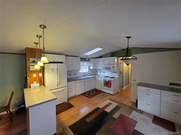 a kitchen with refrigerator and window