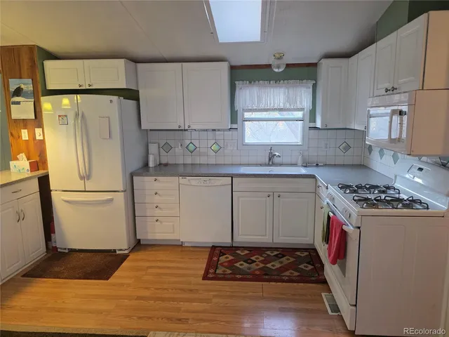 a kitchen with a stove a refrigerator and a cabinets