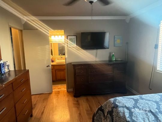 133 South Locust Street Ridgecrest, CA 93555 - Photo 15 of 26 a bedroom with a bed and a television