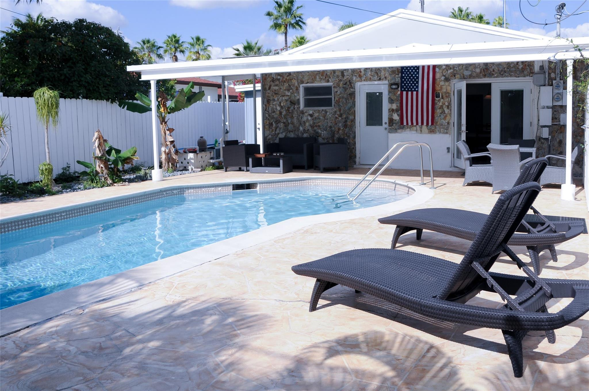 a view of a house with backyard porch and sitting area