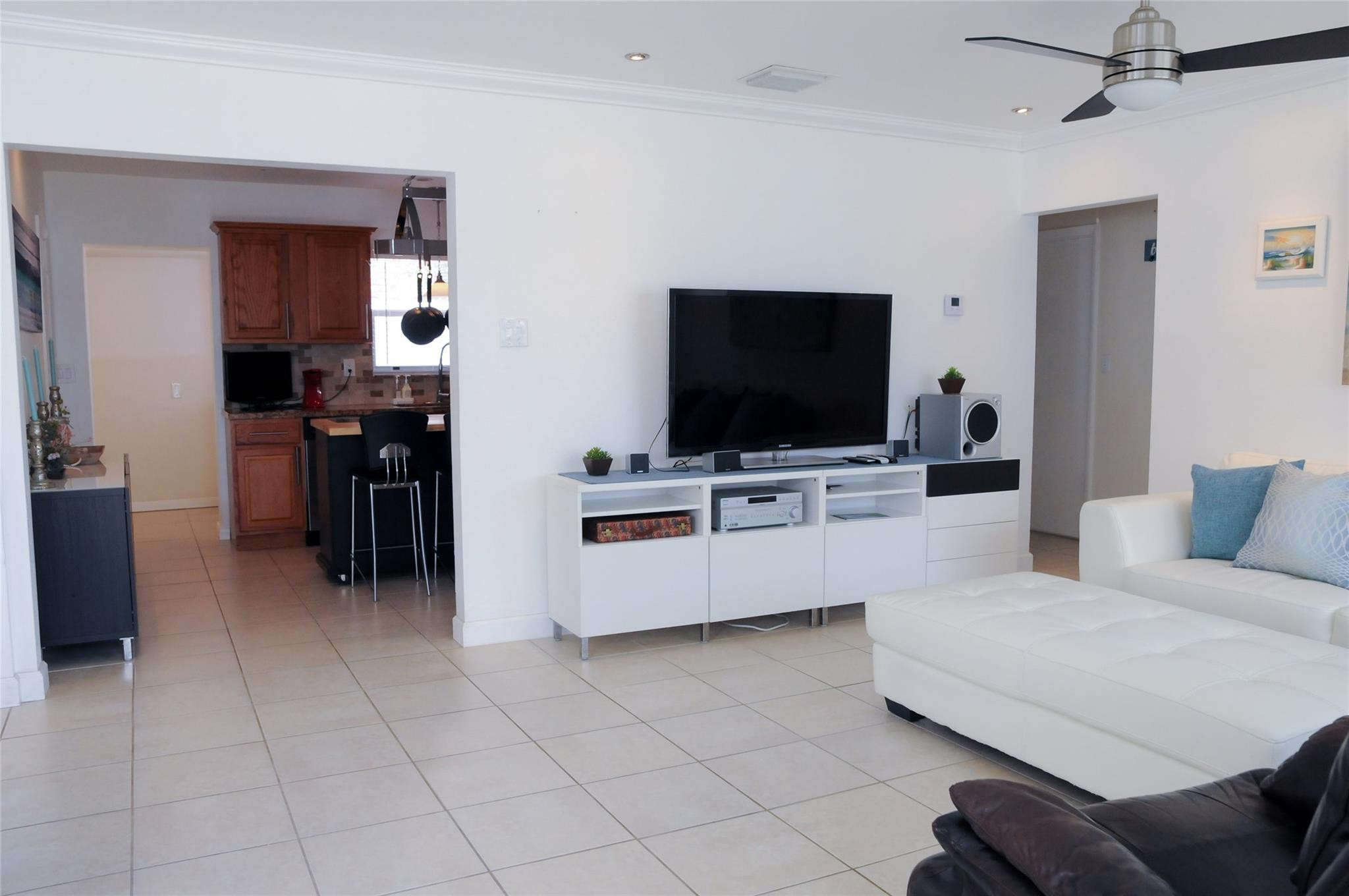 29 Northeast 3rd Street, Unit B Dania Beach, FL 33004 - Photo 11 of 18 a living room with furniture and a flat screen tv
