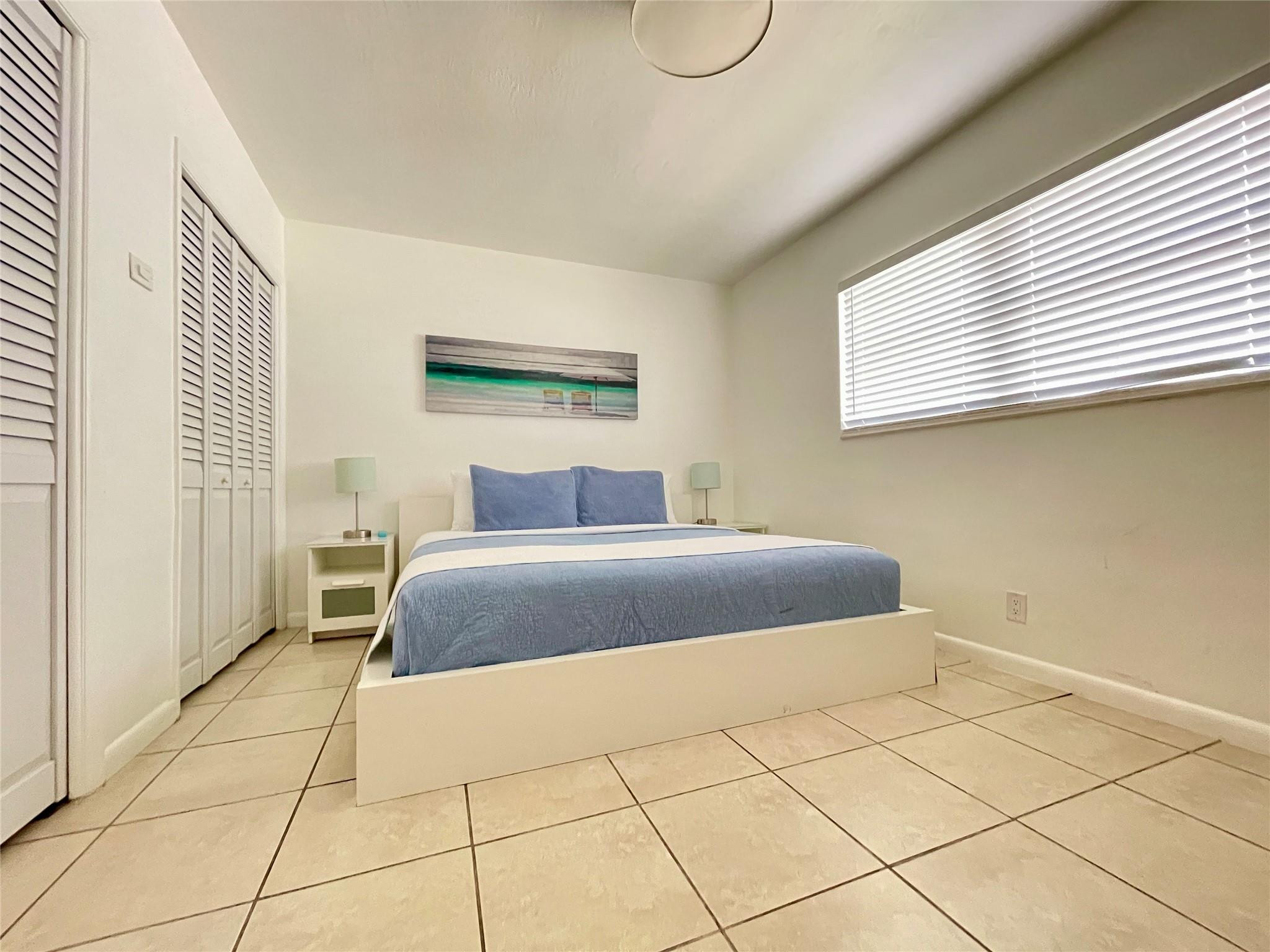 29 Northeast 3rd Street, Unit B Dania Beach, FL 33004 - Photo 12 of 18 a bedroom with a bed and a window