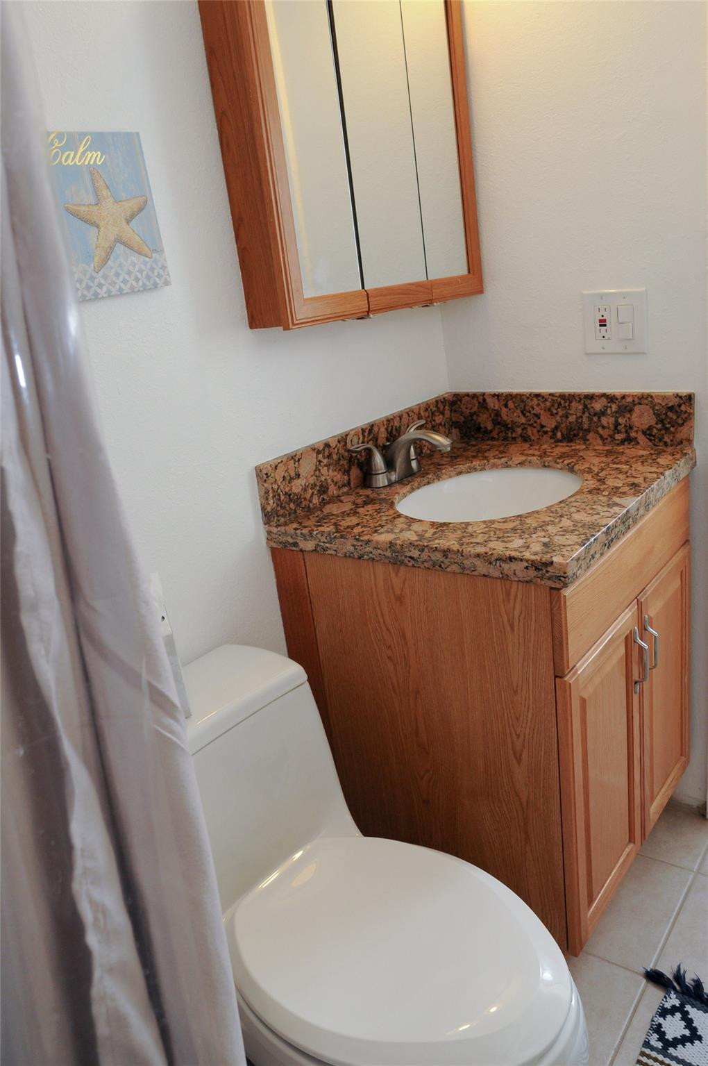 29 Northeast 3rd Street, Unit B Dania Beach, FL 33004 - Photo 14 of 18 a bathroom with a granite countertop toilet and a sink