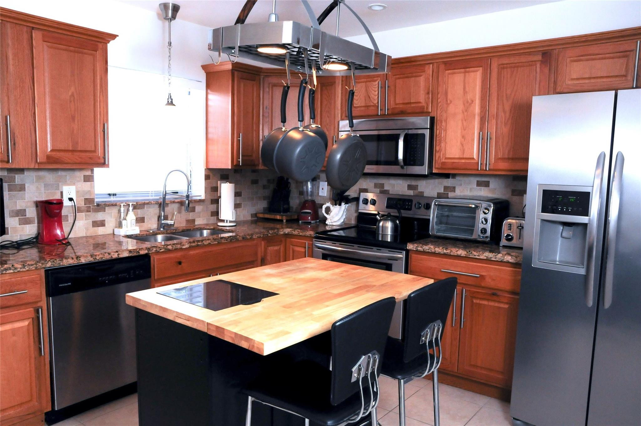 29 Northeast 3rd Street, Unit B Dania Beach, FL 33004 - Photo 5 of 18 a kitchen with stainless steel appliances granite countertop a sink refrigerator and cabinets