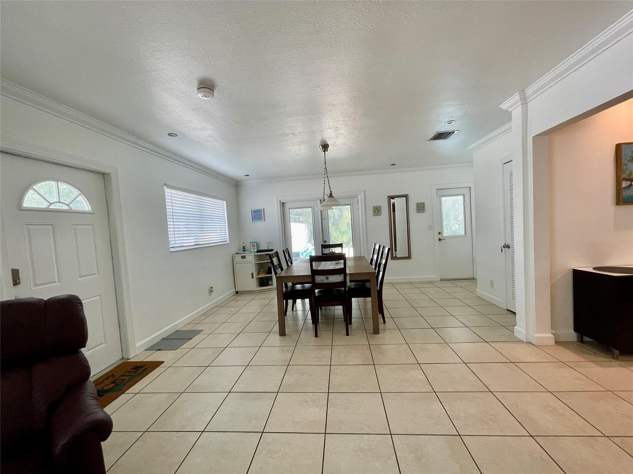 29 Northeast 3rd Street, Unit B Dania Beach, FL 33004 - Photo 6 of 18 a view of a dining room with furniture