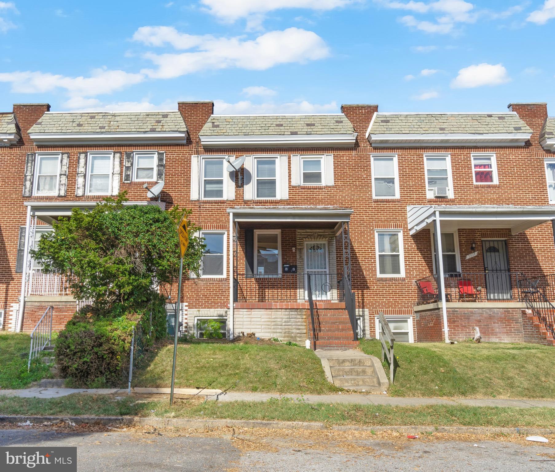 3572 Juneway, Unit 1 Baltimore, MD 21213 - Photo 18 of 23 a front view of a residential apartment building with a yard