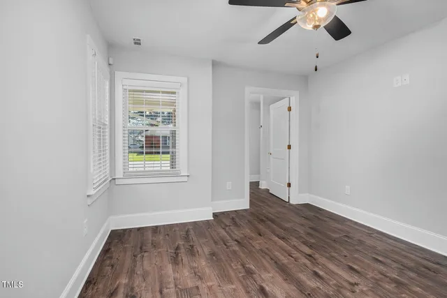 wooden floor in an empty room with a window
