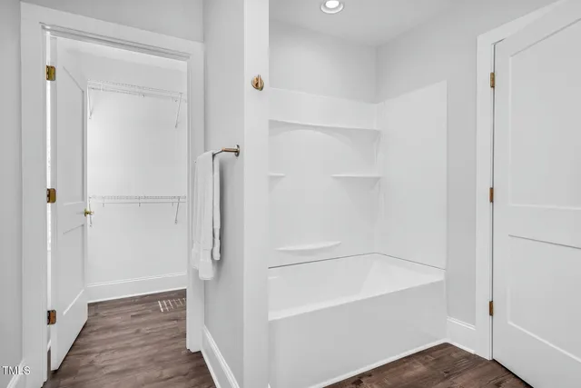 a bathroom with a bathtub and shower