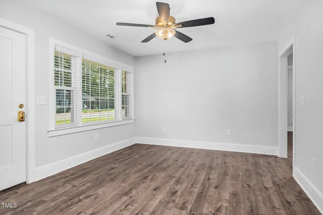 wooden floor in an empty room with a window