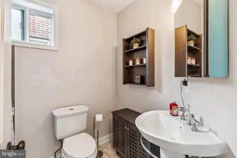 a white toilet sitting next to a bathroom sink