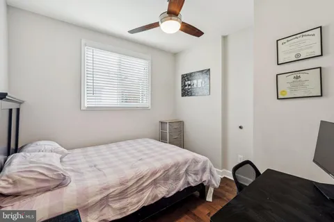 a bedroom with a bed and a desk