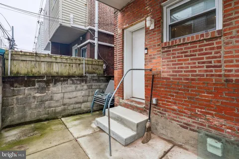 a view of a brick wall with staircase