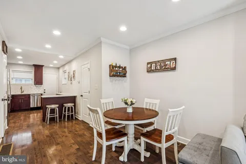 a dining room with furniture and wooden floor