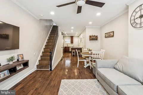 a living room with furniture and wooden floor