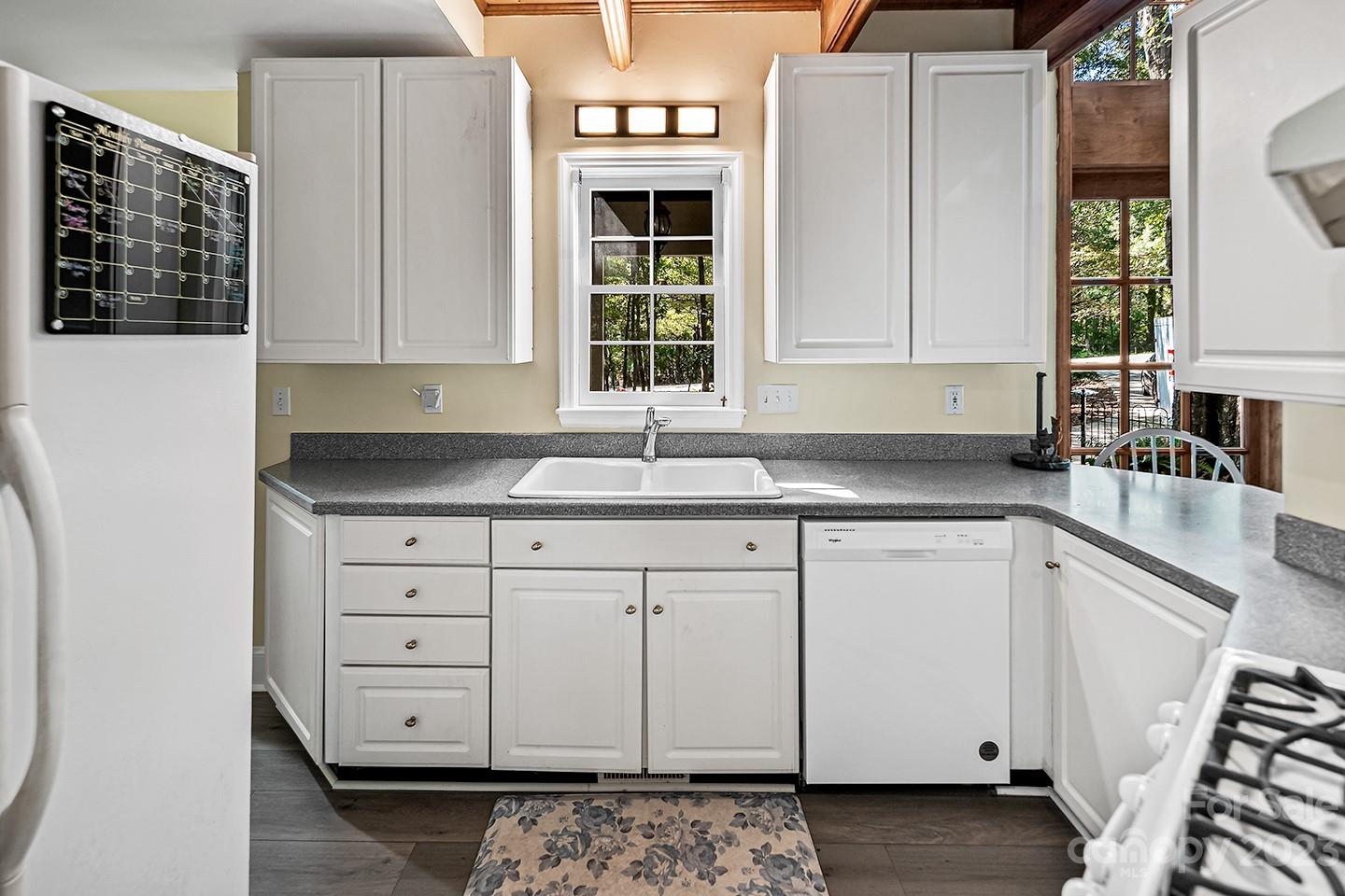 255 Thousand Oaks Road Indian Land, SC 29707 - Photo 11 of 37 a kitchen with granite countertop white cabinets and sink