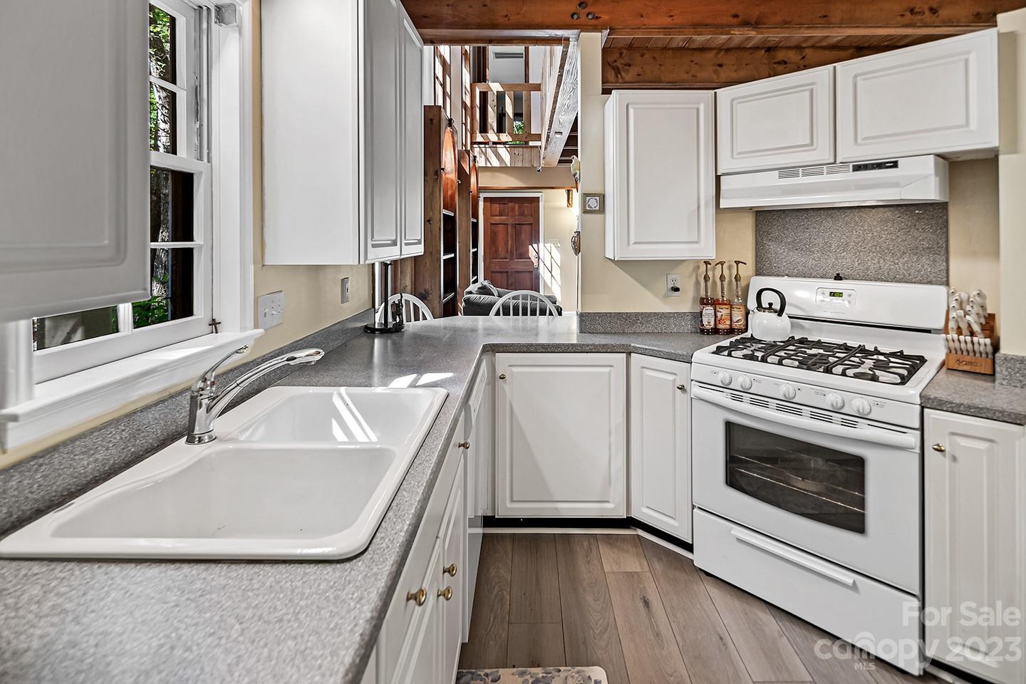 255 Thousand Oaks Road Indian Land, SC 29707 - Photo 12 of 37 a kitchen with granite countertop a sink stainless steel appliances and white cabinets