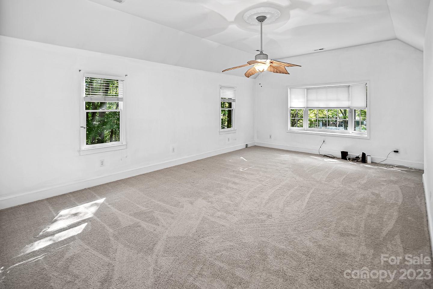 255 Thousand Oaks Road Indian Land, SC 29707 - Photo 16 of 37 an empty room with windows and ceiling fan