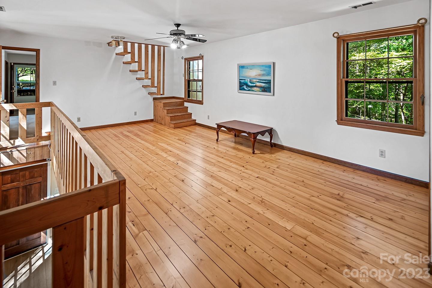 255 Thousand Oaks Road Indian Land, SC 29707 - Photo 22 of 37 a room with wooden floor and furniture
