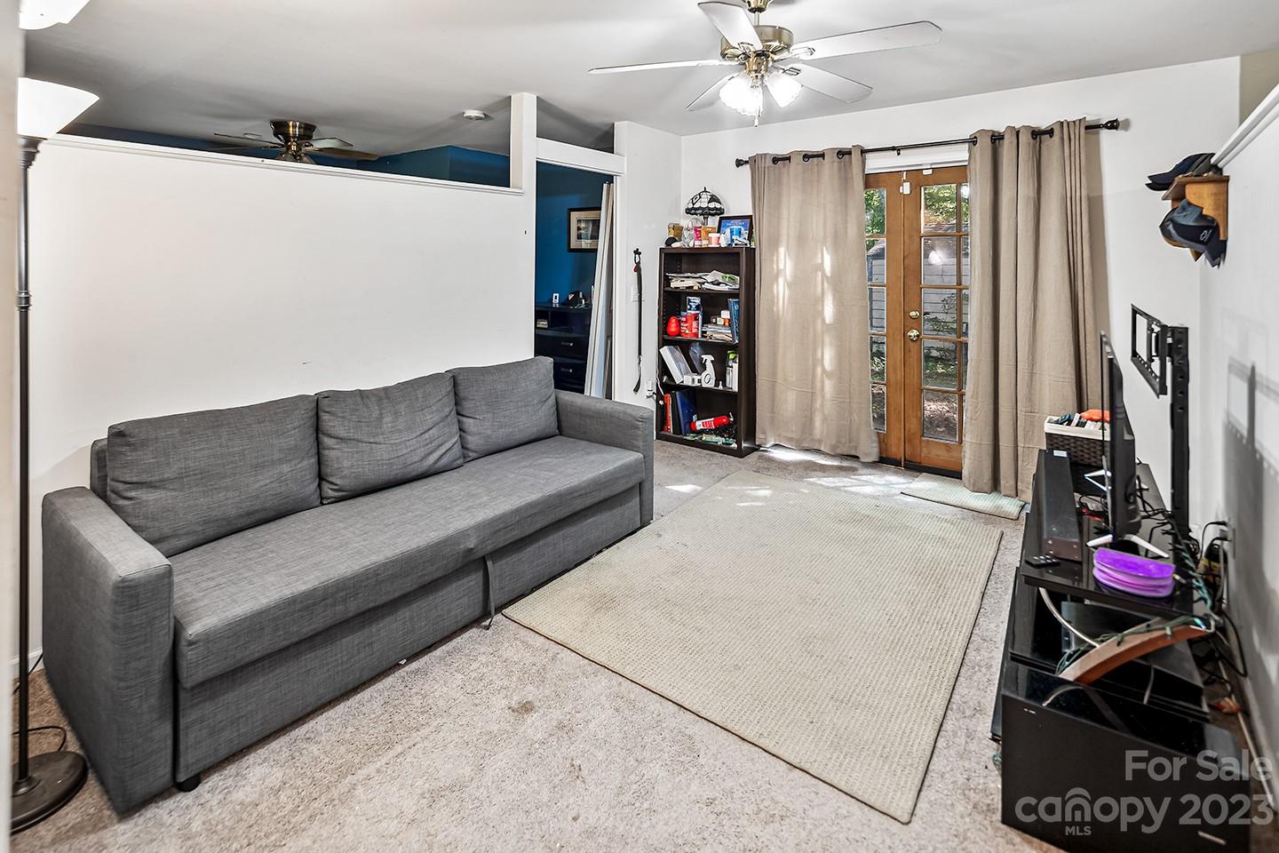 255 Thousand Oaks Road Indian Land, SC 29707 - Photo 34 of 37 a living room with furniture a air conditioner and a ceiling fan