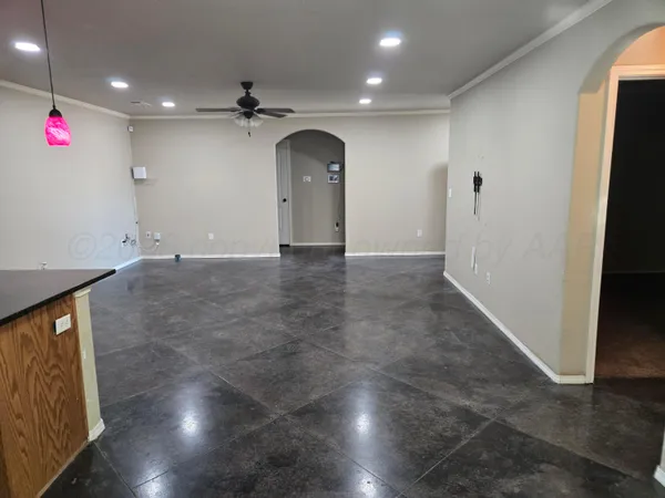 an empty room with wooden floor and entryway