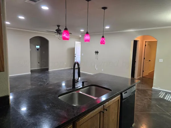 a kitchen view with granite countertop a sink cabinetry and refrigerator