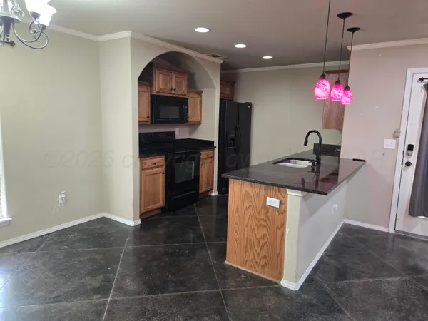 a kitchen with stainless steel appliances granite countertop a sink a stove and a refrigerator