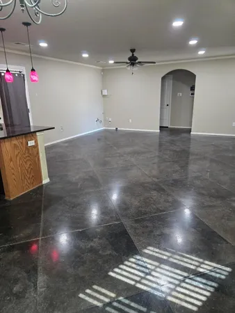 a view of kitchen with granite countertop cabinets and window