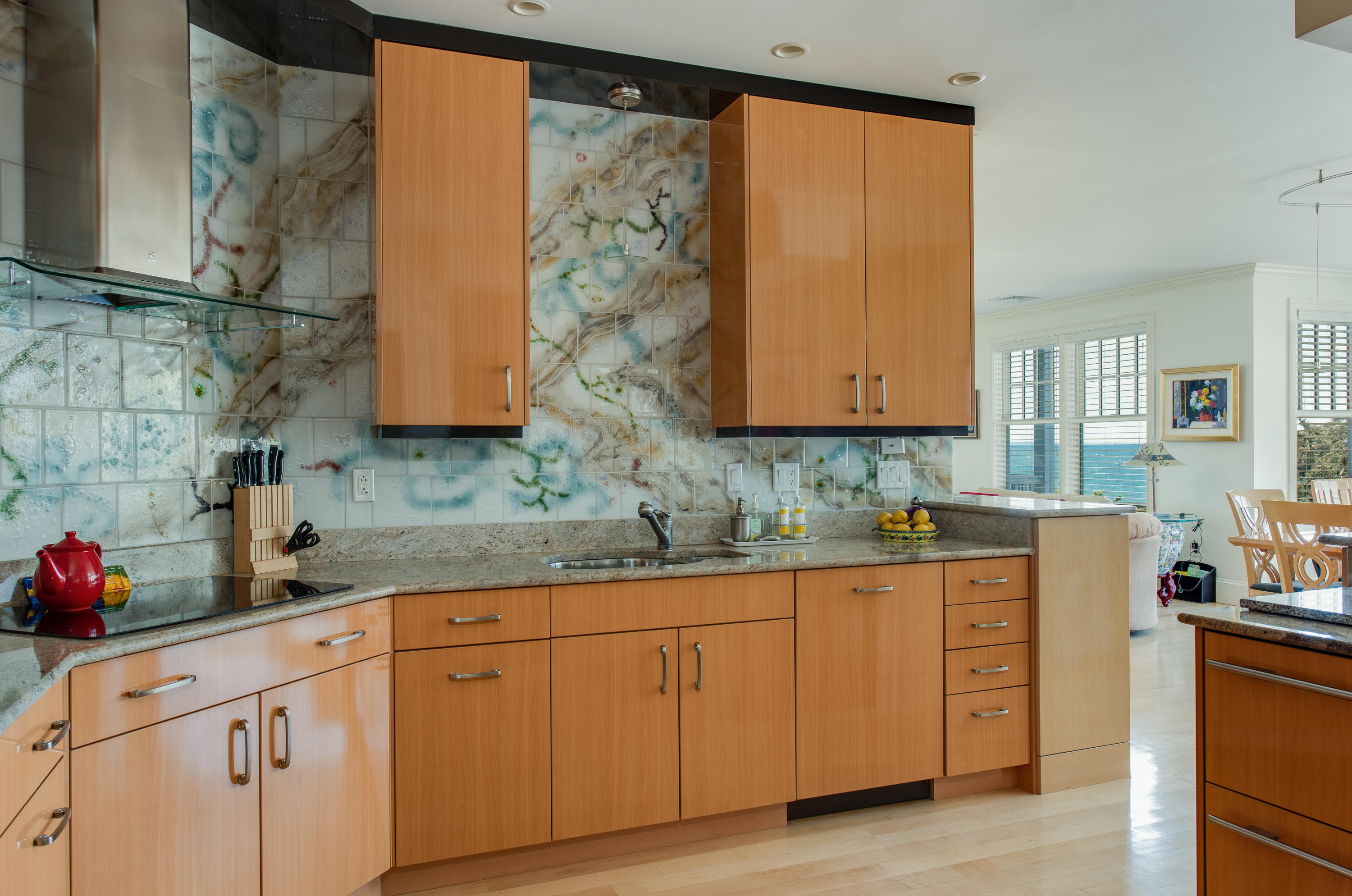 28 Cape Codder Road, Unit 109BU Falmouth, MA 02540 - Photo 13 of 20 a kitchen with stainless steel appliances granite countertop white cabinets sink and dishwasher with wooden floor