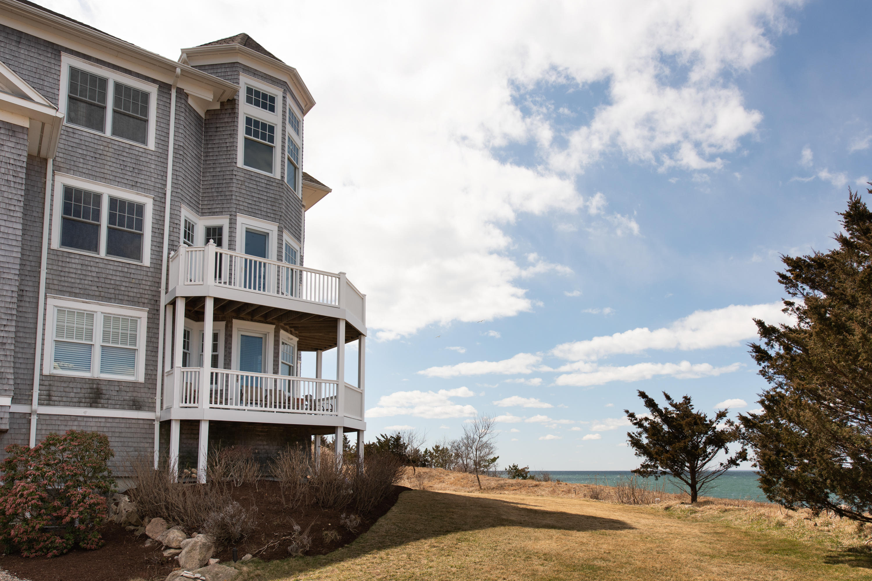 28 Cape Codder Road, Unit 109BU Falmouth, MA 02540 - Photo 19 of 20 a front view of a house with lake view and trees
