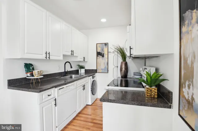a kitchen with stainless steel appliances kitchen island a sink a counter space and cabinets
