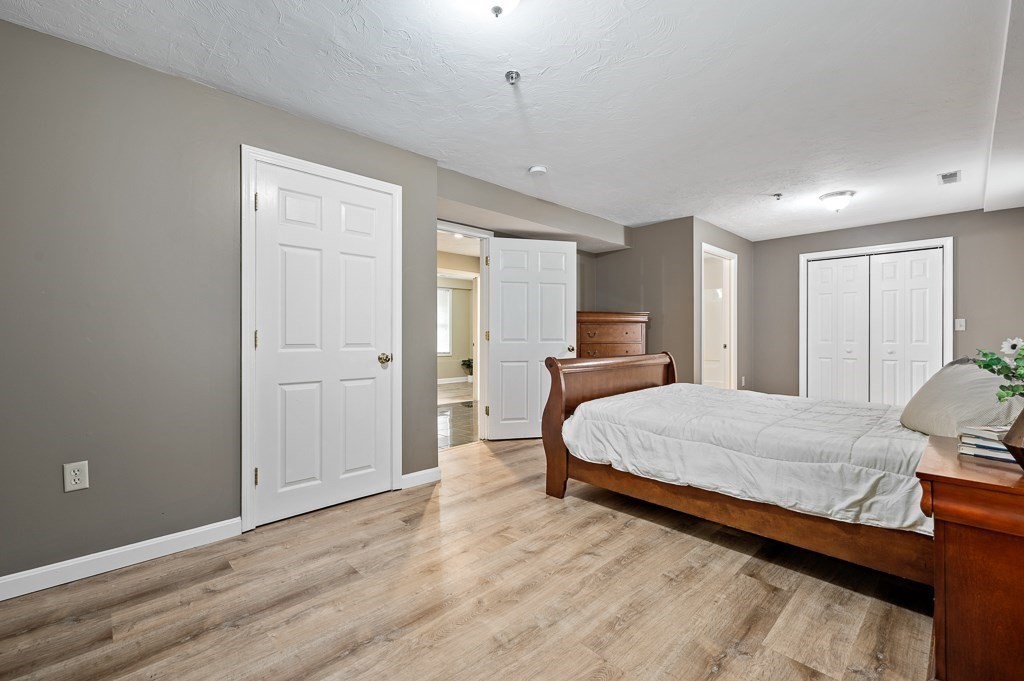 1 Hatfield Street, Unit 3 Worcester, MA 01604 - Photo 14 of 23 a spacious bedroom with a bed and wooden floor