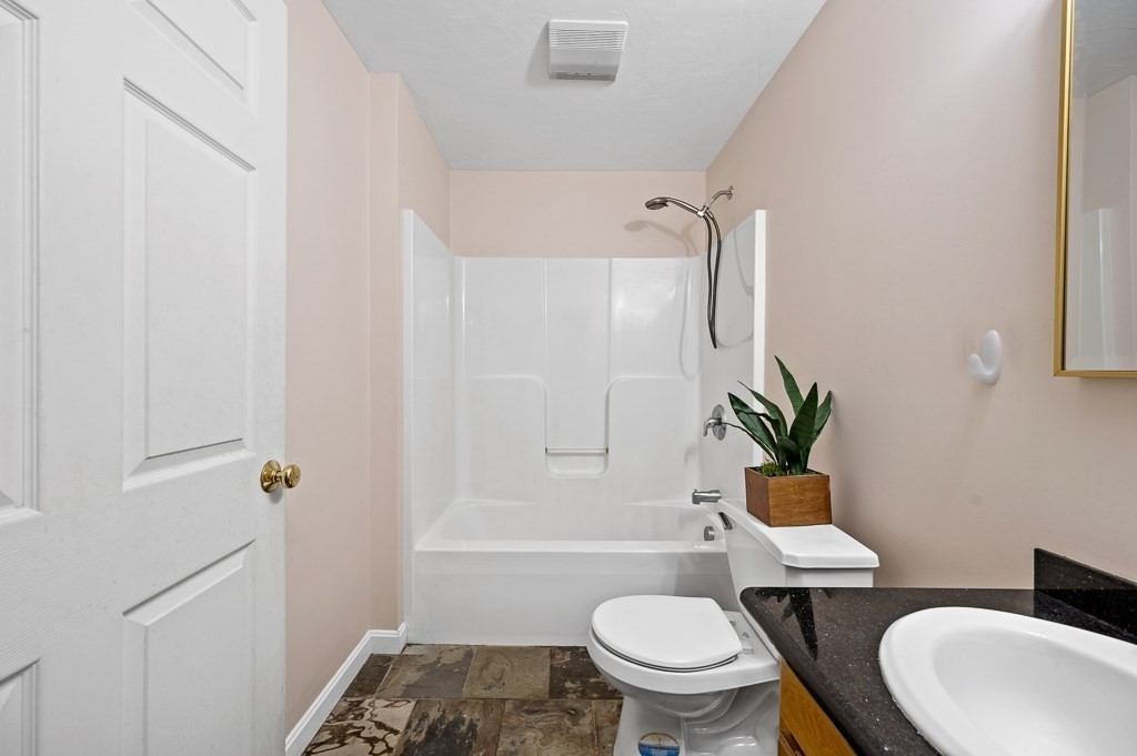 1 Hatfield Street, Unit 3 Worcester, MA 01604 - Photo 16 of 23 a white toilet sitting next to a bath tub