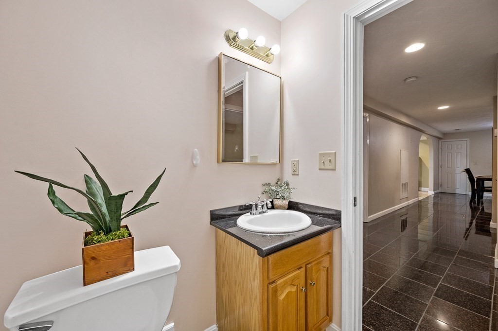 1 Hatfield Street, Unit 3 Worcester, MA 01604 - Photo 17 of 23 a bathroom with a granite countertop sink and a mirror