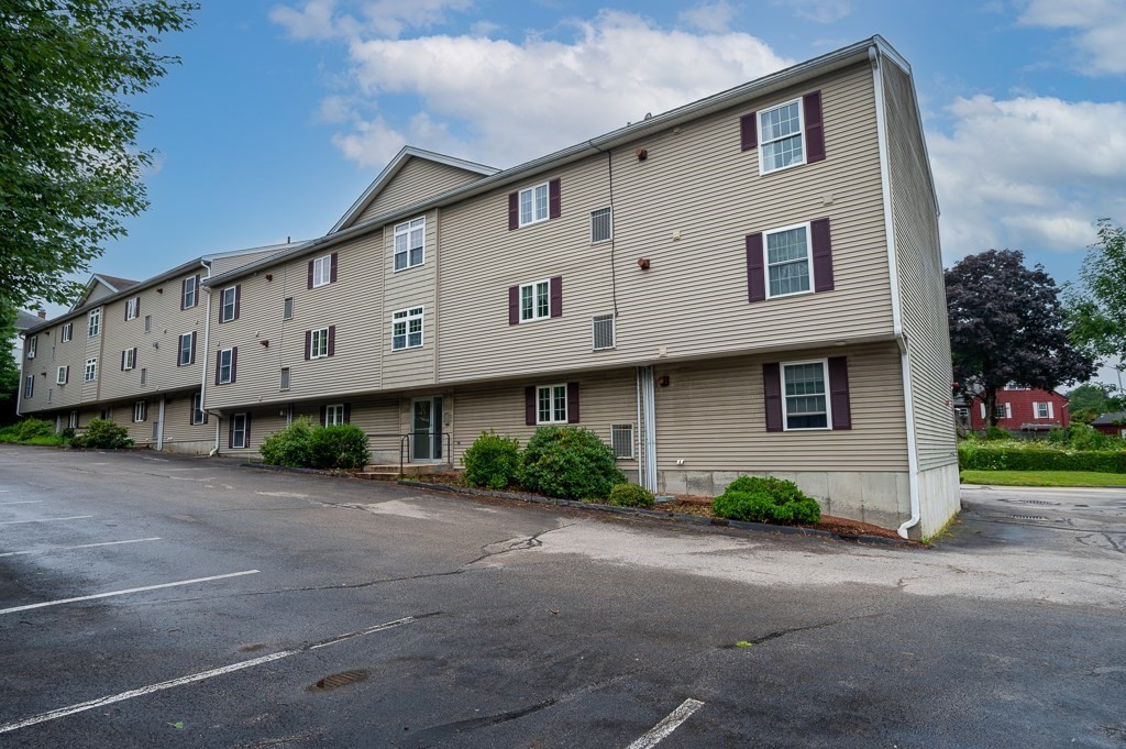 1 Hatfield Street, Unit 3 Worcester, MA 01604 - Photo 2 of 23 a front view of a house with a yard and garage