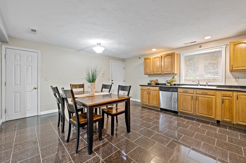 1 Hatfield Street, Unit 3 Worcester, MA 01604 - Photo 10 of 23 a kitchen with a table chairs sink and cabinets