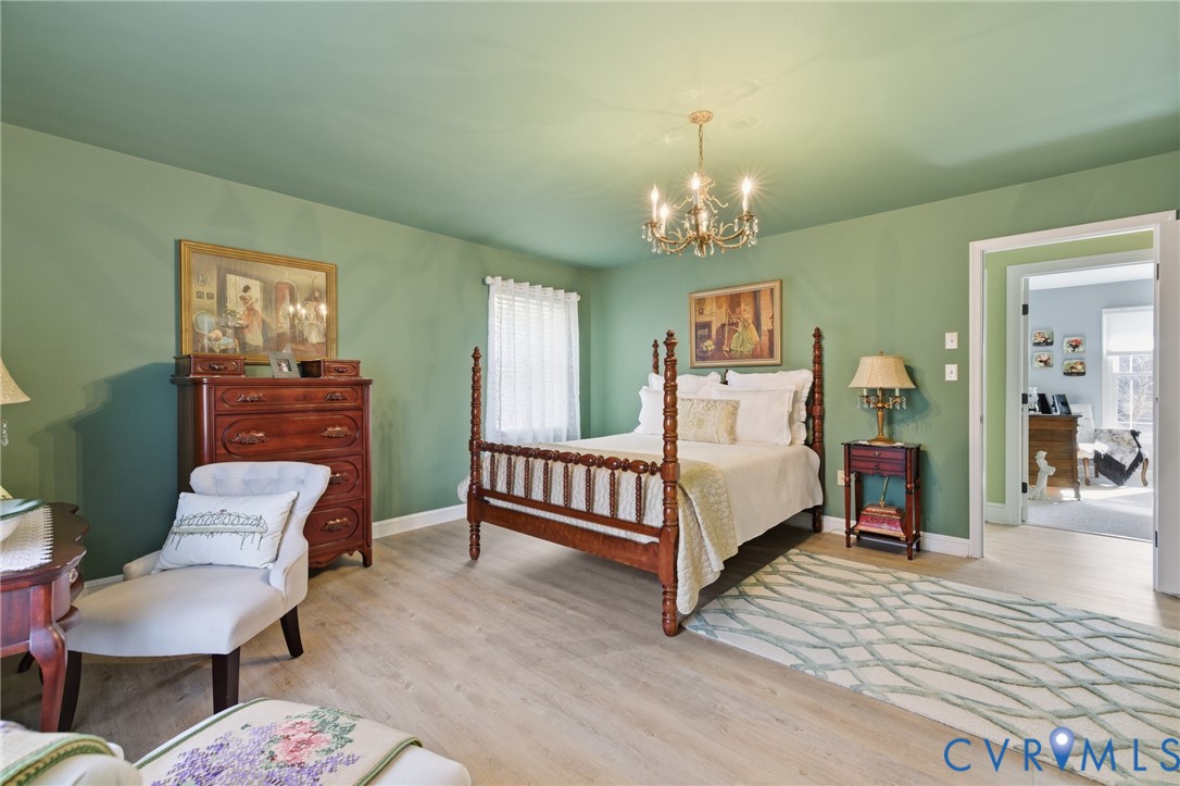 6606 West Quaker Road Disputanta, VA 23842 - Photo 25 of 32 Bedroom with a chandelier and LVP flooring,