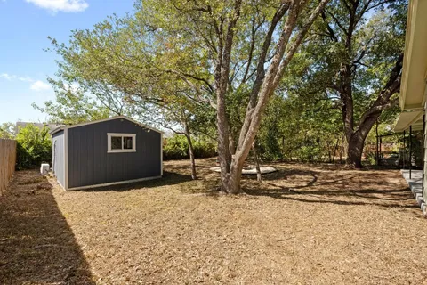 a backyard of a house with large trees
