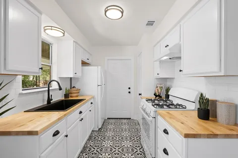 a kitchen with a sink stove and refrigerator