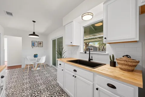 a kitchen with a sink and a stove top oven