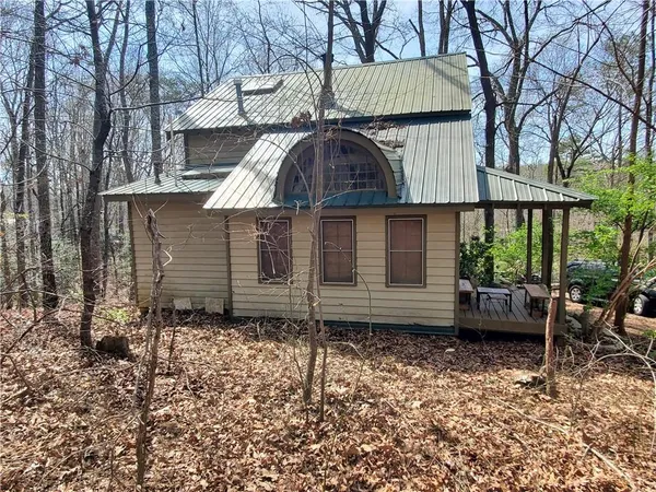 a view of a small house with a garden