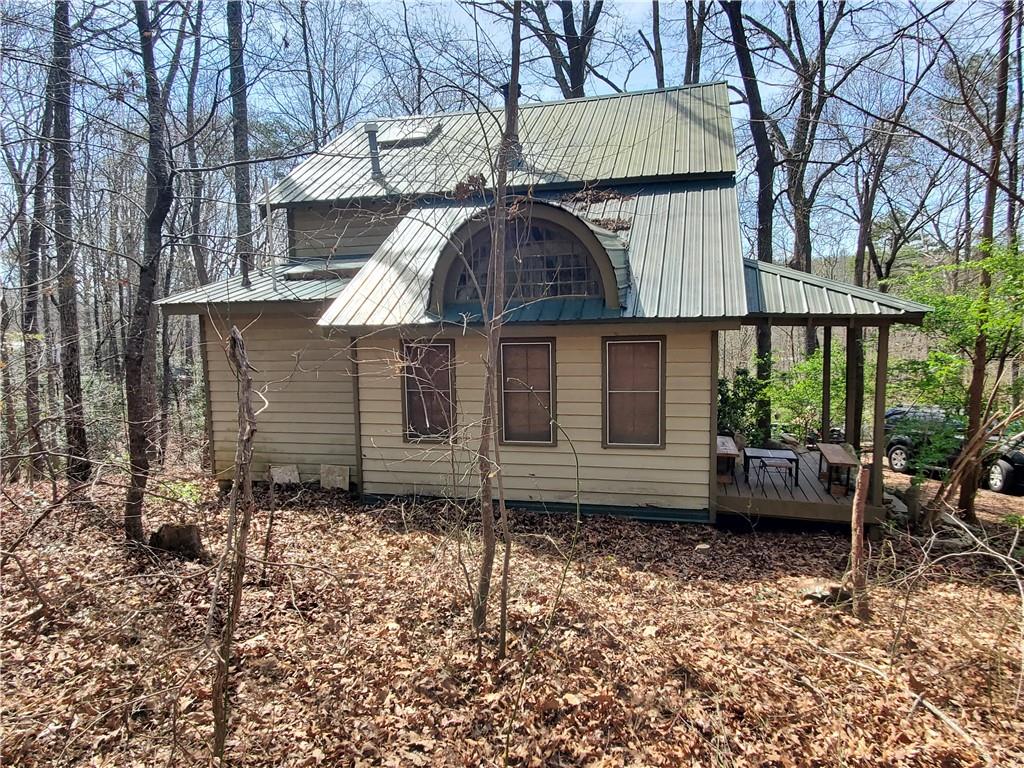 a view of a small house with a garden